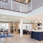 Two story entry welcomes you with a custom stair case and railing. Wood beams accent the expansive ceiling.