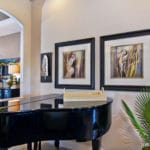Home design ideas include a baby grand piano in coastal living room with tropical artwork and greenery.