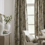 These elegant, traditional floral drapes add color and pattern to this neutral dining room.