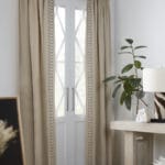 Neutral curtains with decorative tape detail