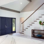 Grand two story entry welcomes you with a custom stair case and railing. Wood beams accent the expansive ceiling.